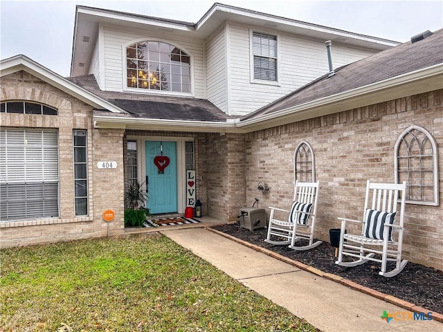 view of exterior entry featuring a yard