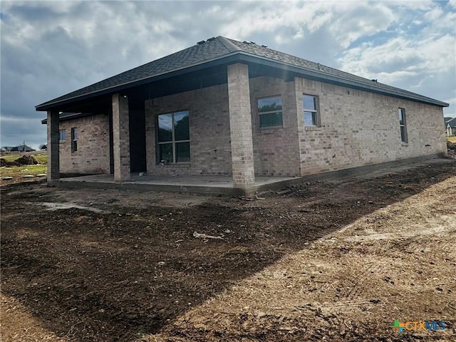 view of side of home featuring a patio area