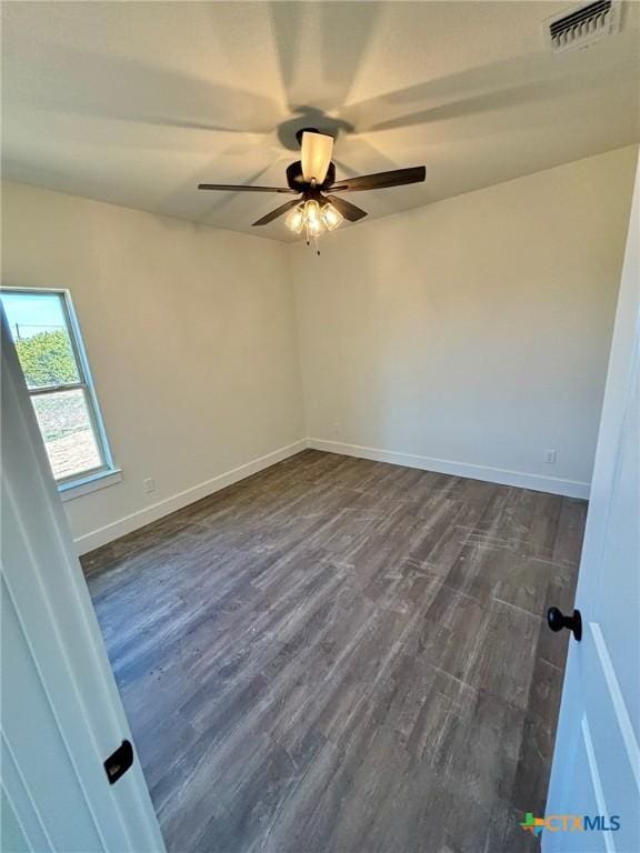 unfurnished room featuring dark wood-type flooring and ceiling fan