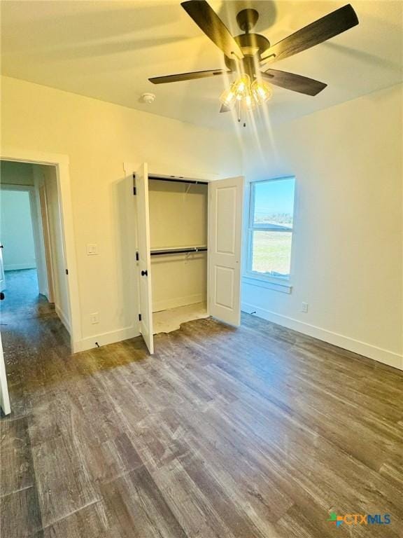 unfurnished bedroom featuring ceiling fan, dark hardwood / wood-style floors, and a closet