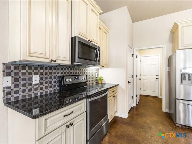 kitchen with finished concrete floors, tasteful backsplash, cream cabinets, and appliances with stainless steel finishes