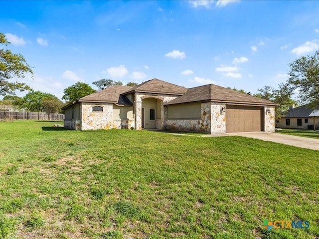 view of front facade featuring stone siding, a garage, a front lawn, and concrete driveway