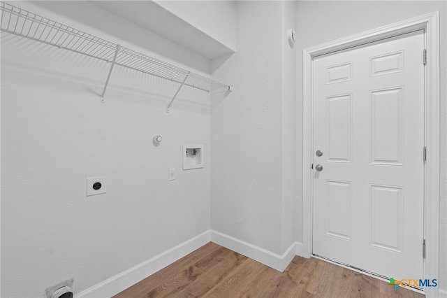 2534 Duval Dr, New Braunfels, TX 78130 - laundry room with hookup for an electric dryer, washer hookup, wood finished floors, and gas dryer hookup