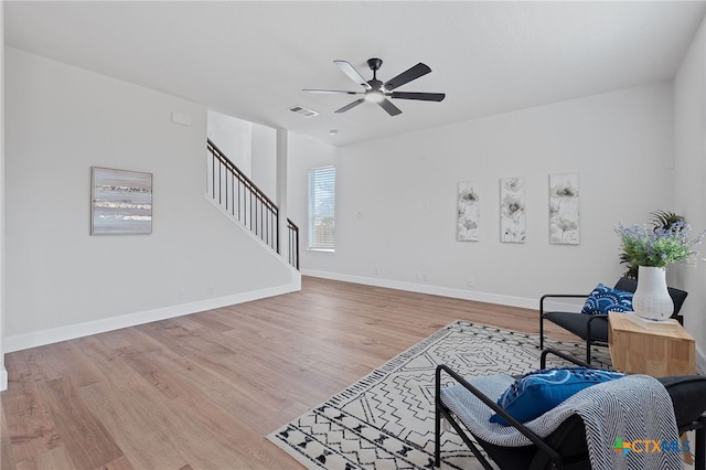 2534 Duval Dr, New Braunfels, TX 78130 - living area with stairs, ceiling fan, and light wood-type flooring