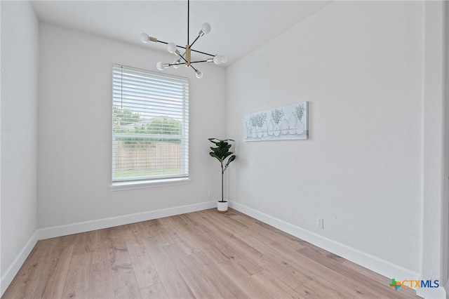 2534 Duval Dr, New Braunfels, TX 78130 - empty room with a chandelier and light wood-type flooring