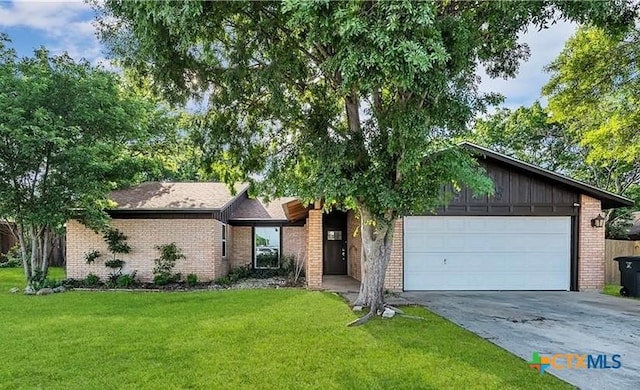 single story home with a front yard and a garage