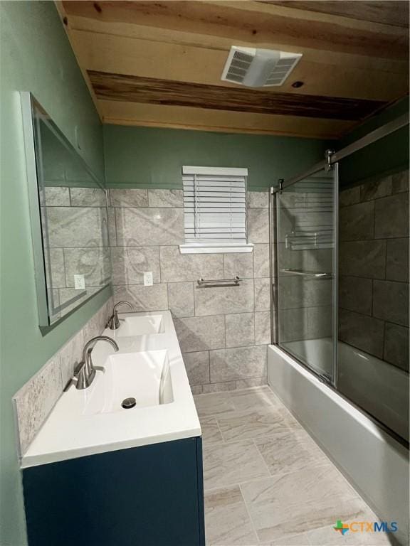 bathroom featuring bath / shower combo with glass door, tile walls, wood ceiling, and vanity