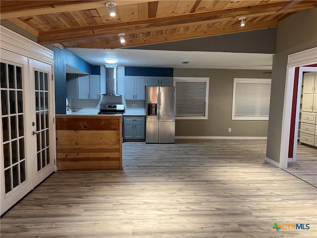 kitchen with wall chimney exhaust hood, stainless steel appliances, french doors, tasteful backsplash, and wooden ceiling