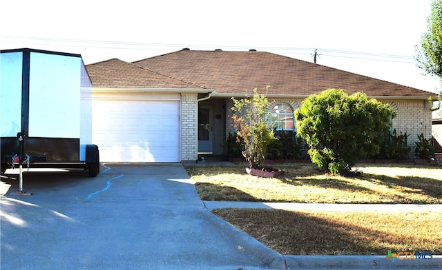 ranch-style home featuring a garage and a front yard