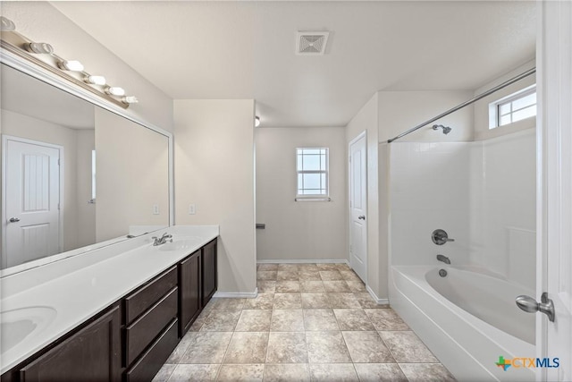 2205 Bald Eagle Ct, Killeen, TX 76549 - bathroom with healthy amount of natural light, double vanity, and shower / washtub combination