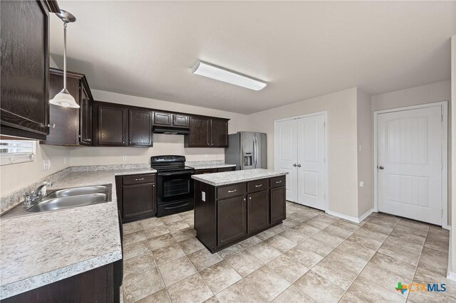 2205 Bald Eagle Ct, Killeen, TX 76549 - kitchen with black range with electric stovetop, stainless steel fridge, light countertops, dark brown cabinets, and under cabinet range hood