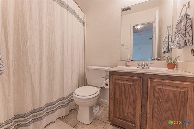 bathroom featuring vanity, tile patterned flooring, and toilet