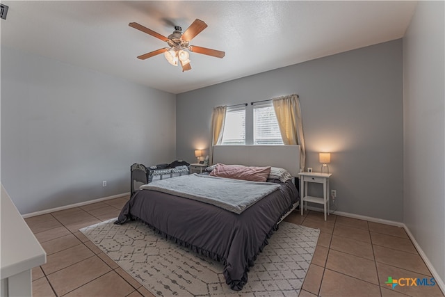 tiled bedroom with ceiling fan