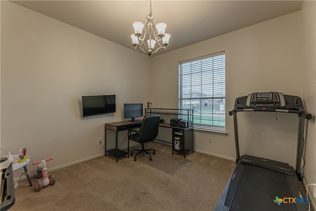 carpeted home office featuring a notable chandelier