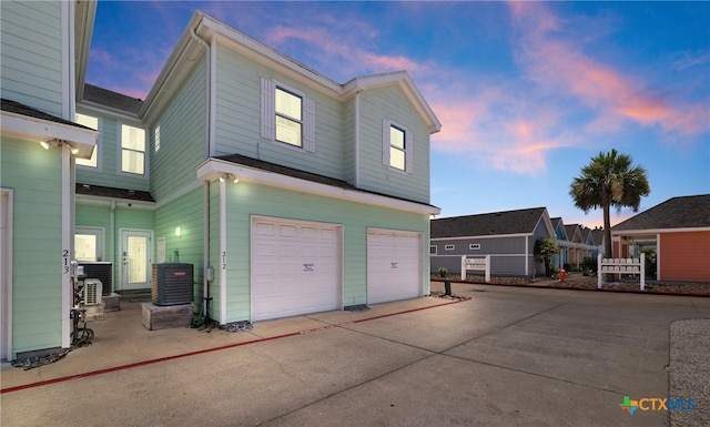 exterior space featuring a garage and central AC