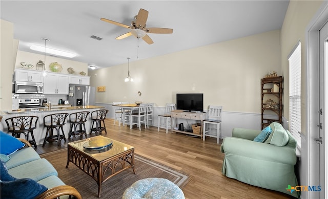 living room featuring hardwood / wood-style flooring and ceiling fan