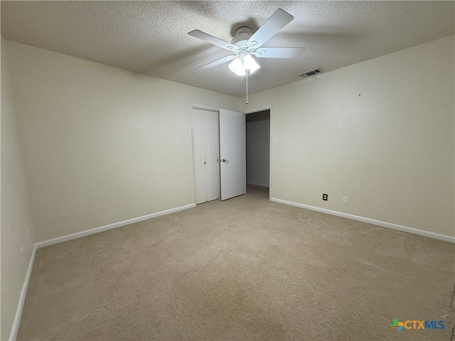 1001 Brookhollow Dr, Port Lavaca, TX 77979 - unfurnished room with light colored carpet, ceiling fan, and a textured ceiling