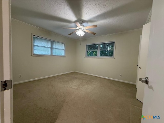 1001 Brookhollow Dr, Port Lavaca, TX 77979 - carpeted empty room featuring ornamental molding, a ceiling fan, and a textured ceiling