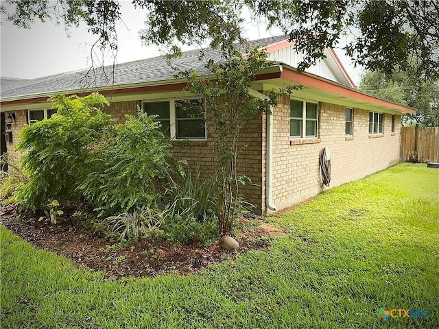 1001 Brookhollow Dr, Port Lavaca, TX 77979 - view of property exterior featuring brick siding, roof with shingles, and board and batten siding