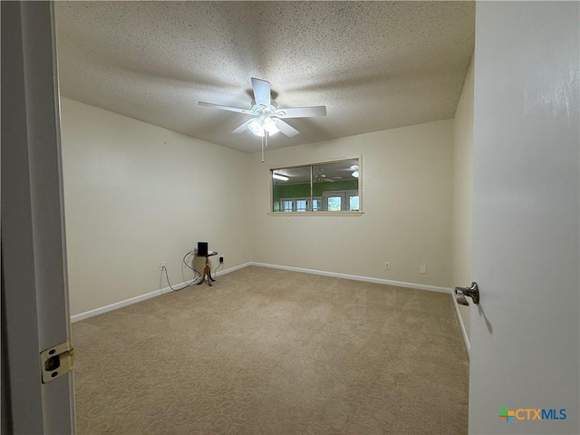 1001 Brookhollow Dr, Port Lavaca, TX 77979 - carpeted empty room featuring ceiling fan and a textured ceiling