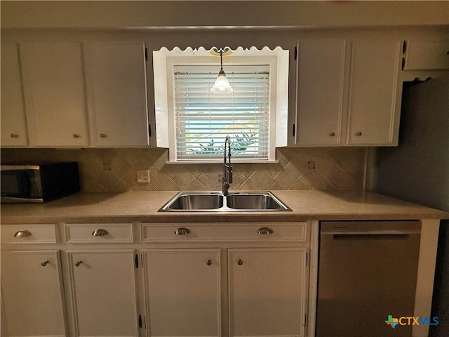 1001 Brookhollow Dr, Port Lavaca, TX 77979 - kitchen featuring stainless steel dishwasher, white cabinets, light countertops, and tasteful backsplash