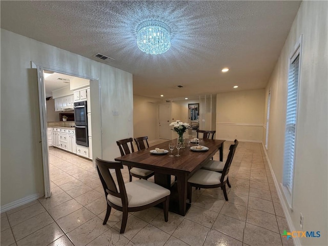 1001 Brookhollow Dr, Port Lavaca, TX 77979 - dining area with a textured ceiling, light tile patterned floors, a chandelier, and recessed lighting