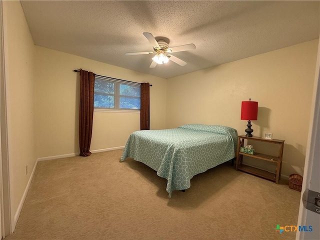 1001 Brookhollow Dr, Port Lavaca, TX 77979 - carpeted bedroom featuring a textured ceiling and a ceiling fan