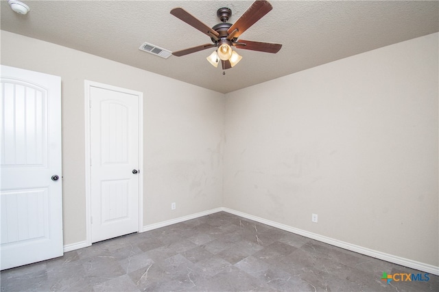 spare room featuring a textured ceiling and ceiling fan