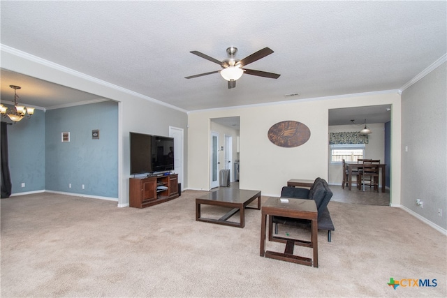 living room featuring light colored carpet, crown molding, a textured ceiling, and ceiling fan with notable chandelier