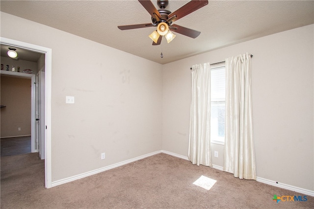 unfurnished room with a textured ceiling, light colored carpet, and ceiling fan