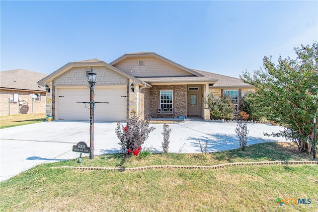 view of front of home featuring a garage and a front lawn