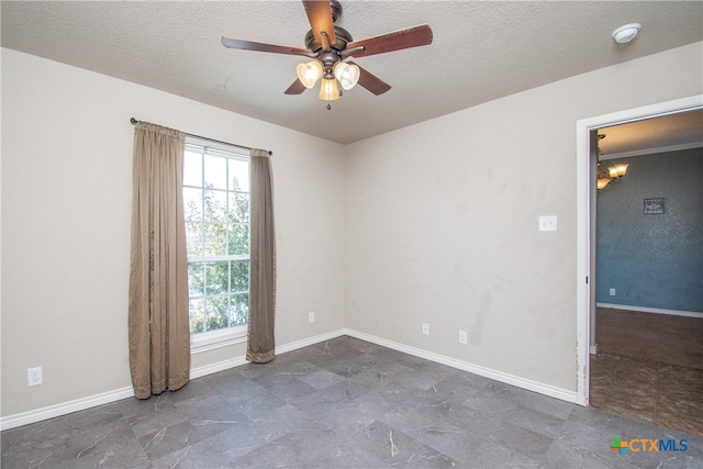 spare room featuring ceiling fan and a textured ceiling