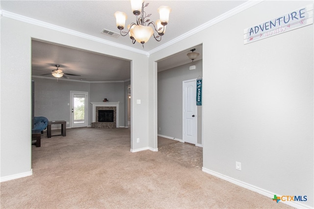 living room featuring ceiling fan with notable chandelier, light colored carpet, a brick fireplace, and crown molding