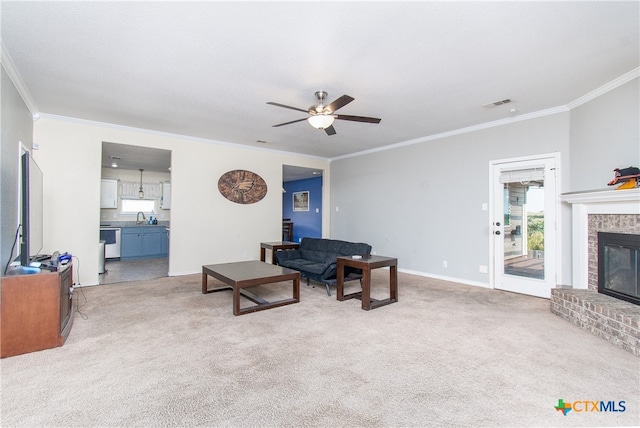 living room featuring a brick fireplace, light carpet, and crown molding