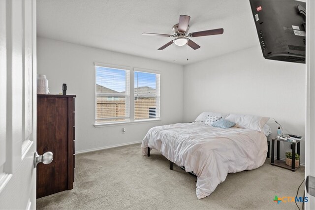 bedroom with light colored carpet and ceiling fan