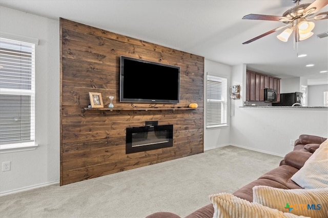 living room featuring ceiling fan and light colored carpet