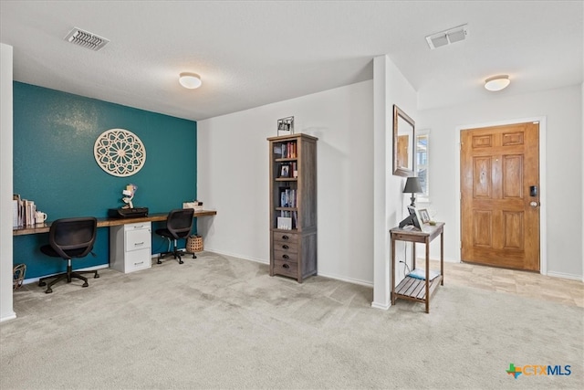 carpeted office featuring built in desk