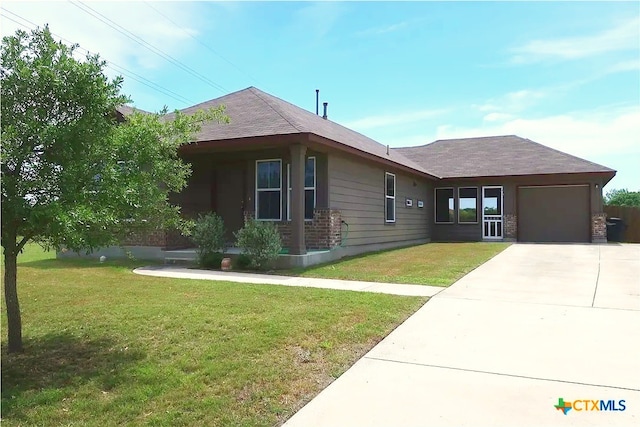 ranch-style house featuring an attached garage, driveway, a front yard, and roof with shingles