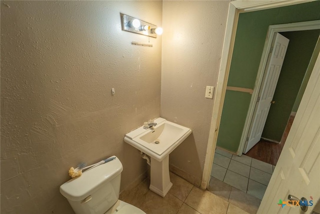 bathroom featuring tile patterned flooring and toilet