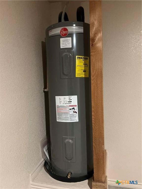 utility room featuring electric water heater