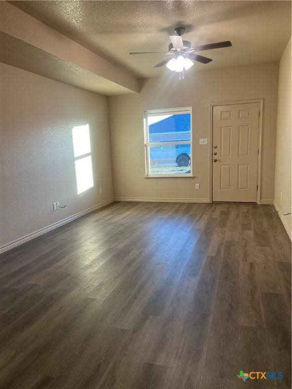 interior space with ceiling fan, plenty of natural light, and a textured ceiling