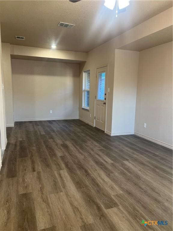 spare room with ceiling fan and dark hardwood / wood-style flooring