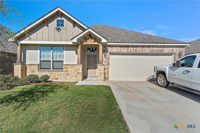 view of front of property with a front yard and a garage