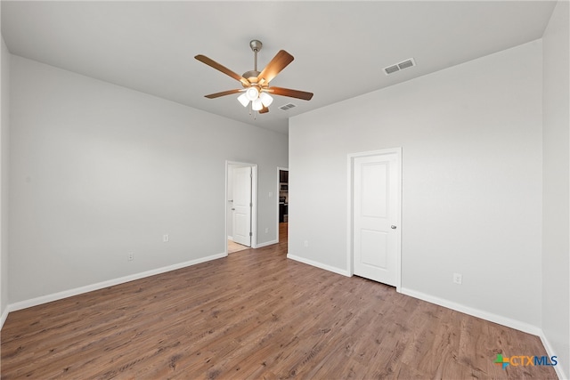 empty room featuring hardwood / wood-style flooring and ceiling fan