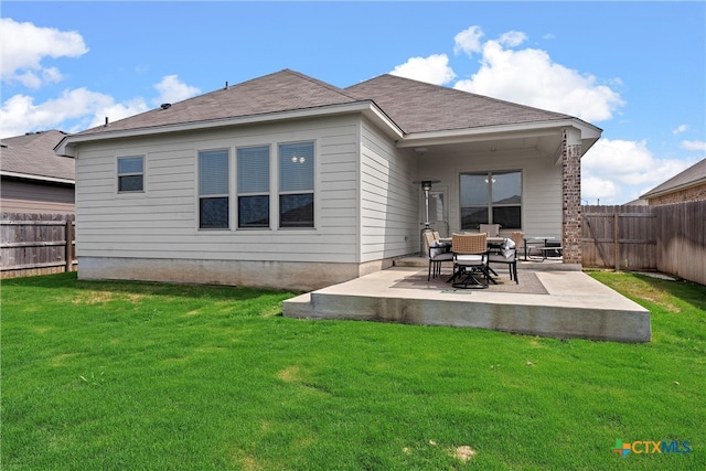 back of property featuring a yard and a patio