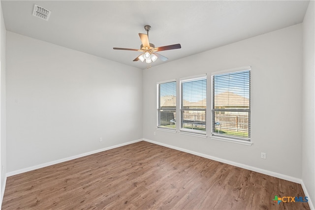 empty room featuring ceiling fan and wood-type flooring