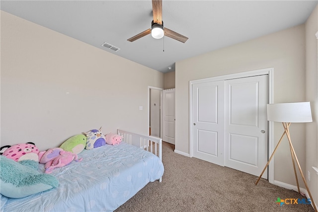 carpeted bedroom featuring ceiling fan and a closet