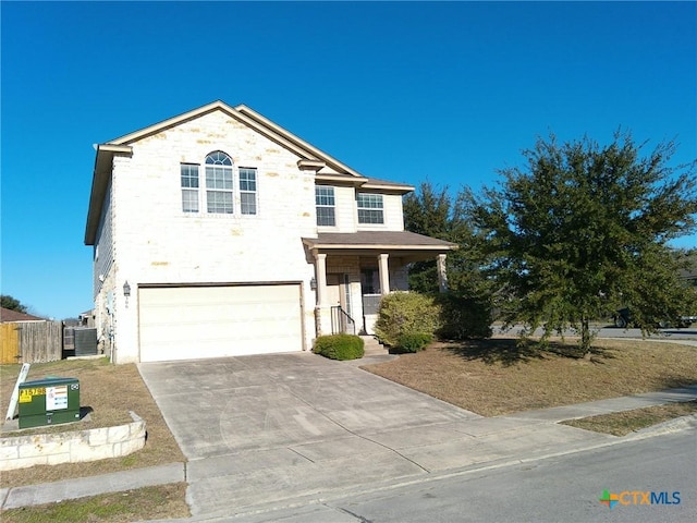 view of front facade featuring a garage, central AC, and a porch