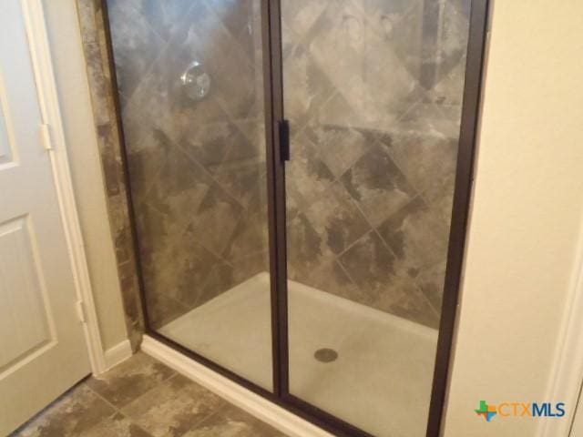 bathroom with a shower with shower door