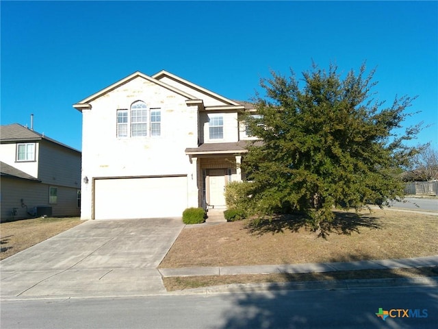 view of front of property with central AC and a garage